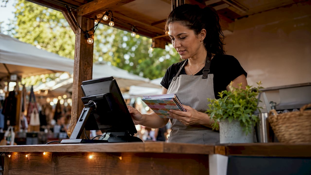 Retail manager using cloud POS at store counter